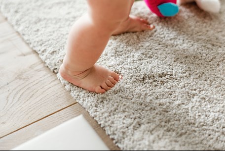 baby walking on carpet in Stromsburg NE